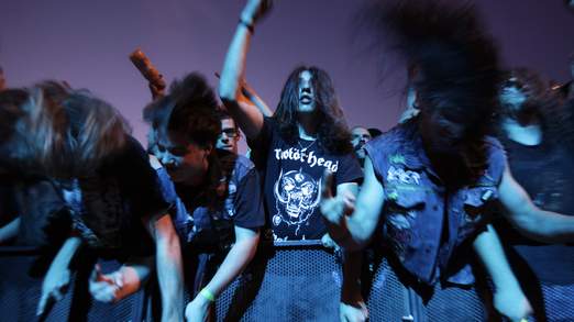 Fans of the band Motorhead shake their heads during their performance at the 35th Paleo music festival in Nyon